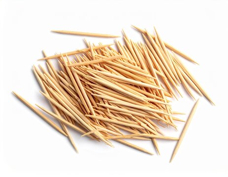 A scattered pile of sharp wooden toothpicks isolated on a white background. Dental hygiene or cocktail garnish concept.
