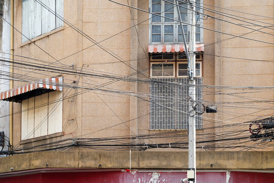 Tangled Utility Wires Across Urban Building