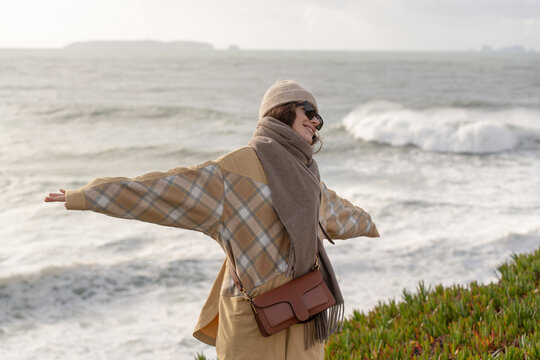 Woman enjoying freedom beside the Atlantic Ocean