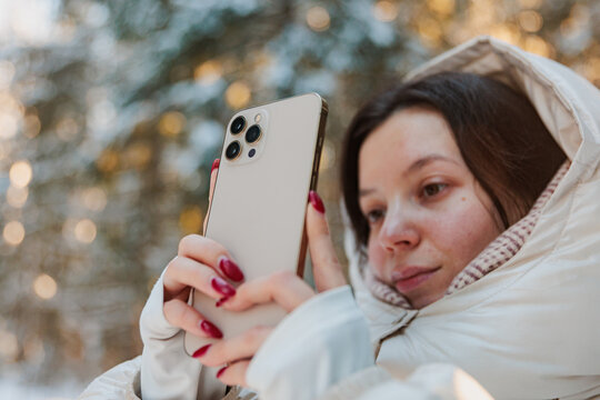Cute Woman Taking Picture in Fairy Snowy Forest During Winter Season