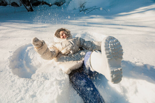 Person Playing in Snow During Winter Day in Outdoor Setting