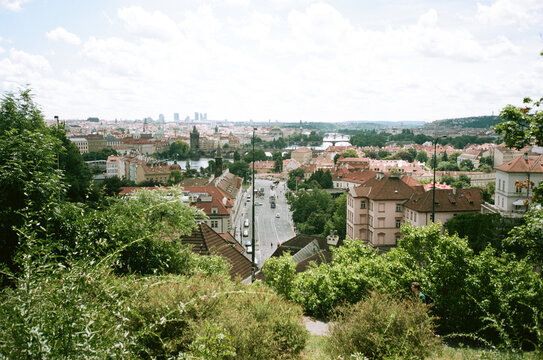 Panoramic view of Prague with red rooftops and green parks