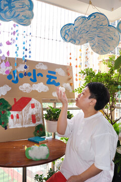 Chinese female teacher and the props she made for a drama class