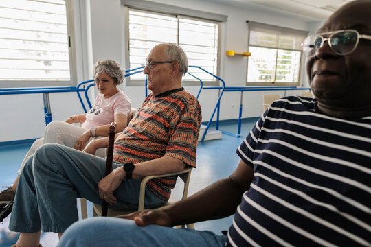 Diverse senior adults sitting in rehabilitation facility