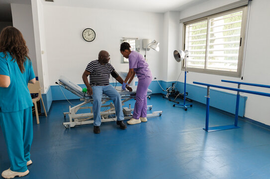 Nurse measuring blood pressure of a male patient