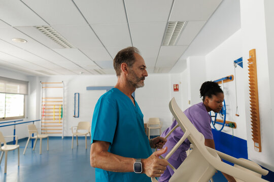 Healthcare team preparing rehabilitation room for therapy session
