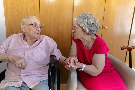 Senior couple sharing intimate moment, holding hands