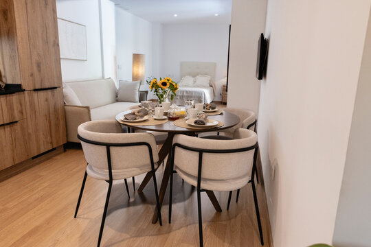 Modern studio apartment interior serving breakfast for two