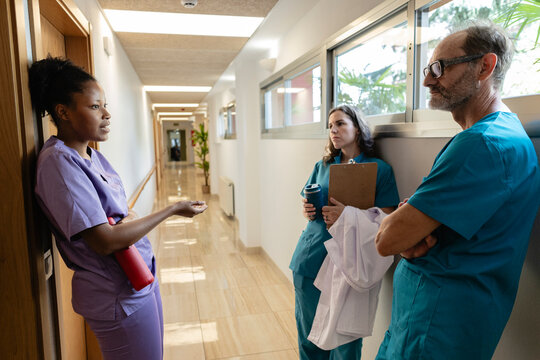 Healthcare professionals having serious conversation in