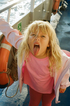 Girl Makes a Funny Face While on a Boat in the Water