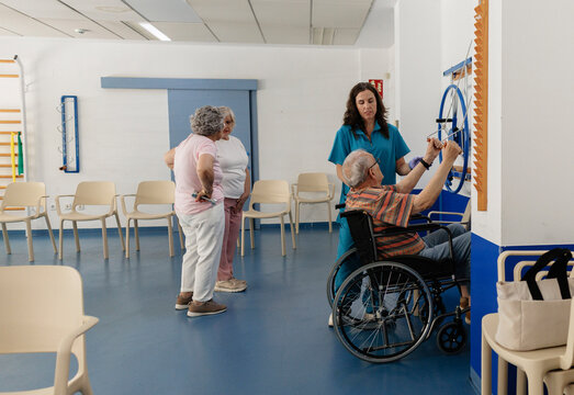 Senior man in wheelchair doing physical therapy exercise