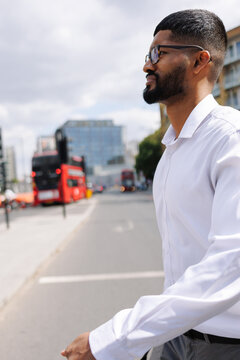 Young businessman waiting to cross London city street