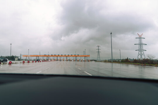 Distant view of toll road crossing gates from the car windshield