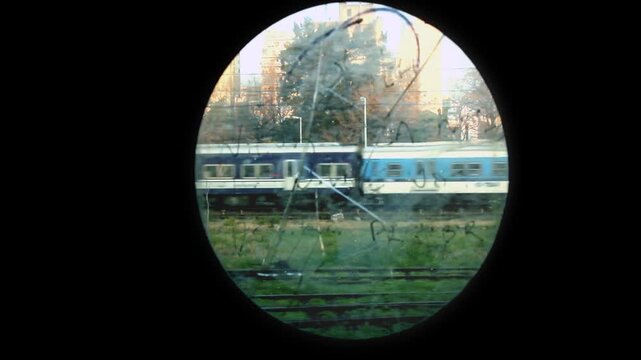 Passenger Train Seen Through Round Window of Old Carriage, Buenos Aires, Argentina