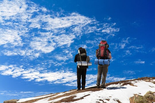 Two hikers backpakers or tourists with a big backpack