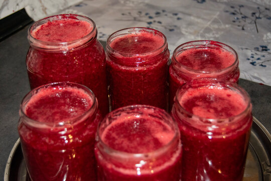 Freshly Filled Hot Sour Cherry Jam Jars On Metal Tray