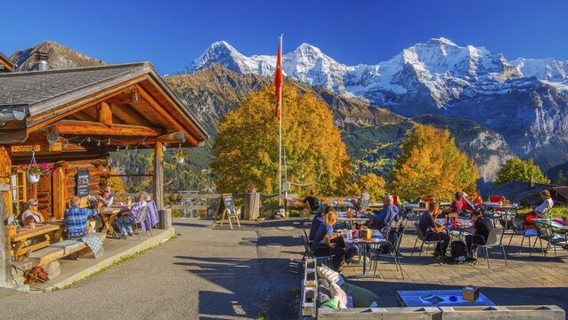 Sun terrace of the mountain inn in the hamlet of Sulwald with Eiger 3967m, M&ouml;nch 4110m and Jungfrau 4158m in autumn, Isenfluh, Lauterbrunnental, Bernese Oberland, Canton of Bern, Switzerland