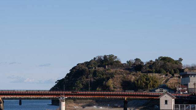 Scenic view of Kumano River Kumano Bridge and Tsurugajo Castle Ruins under clear blue sky in Shingu Wakayama Japan