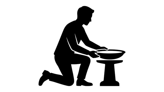 Man Washing Hands: A silhouette of a man kneeling and washing his hands in a shallow bowl, illustrating hygiene and cleanliness practices.
