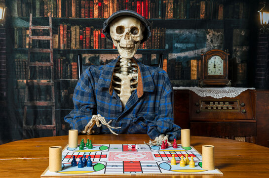 skeleton waiting for someone to play parcheesi