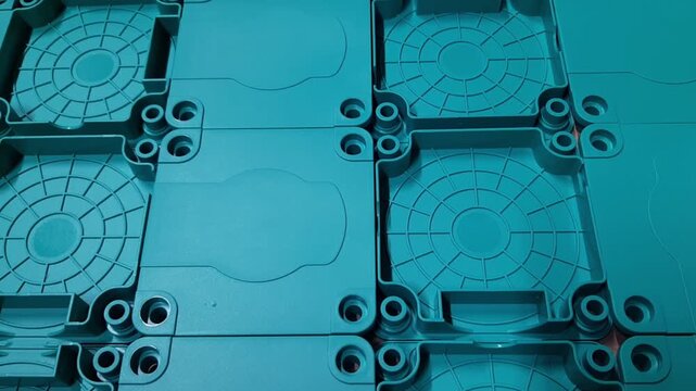 Smooth camera movement over industrial plastic parts texture. Abstract background of manufactured polymer components, mass production, injection molding elements and technical industry concept.