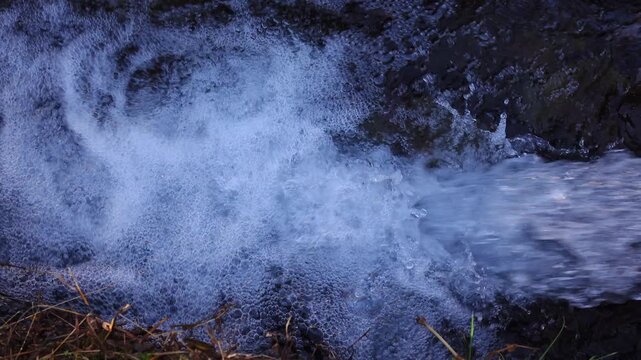 crystal water on fresh stream at vintage village in Shirakawago, Japan.