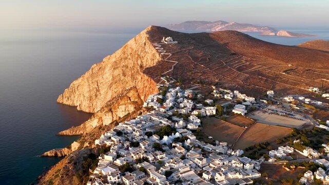 Aerial view of the town Chora of Folegandros island, Cyclades, Greece, during a golden summer sunset