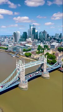 Aerial hyperlapse view of the skyline of London, England, with Tower Bridge, River Thames and City skyscrapers during a summer day