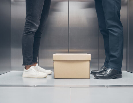 Simple box on the elevator floor between two people