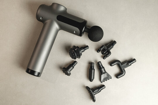 Percussion massager with interchangeable attachments for deep tissue