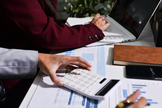 Business people analyzing monthly budget and financial report using data and chart to strategize and plan for their future business while working together in the office.