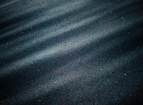 Dramatic light on the street asphalt background