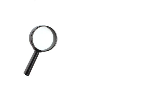 There is a black magnifying glass on a grey background.