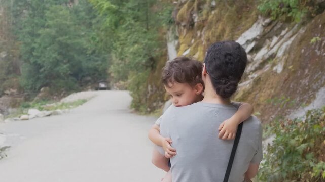 Tender Moment: Mother Carries Her Loving Child Along the Scenic Othello Tunnels Trail, British Columbia