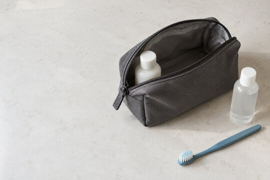 Open Toiletry Bag with Bottles and a Toothbrush