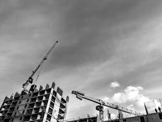 Modern construction site with cranes and rising residential building in black and white © LemPro Filming Life