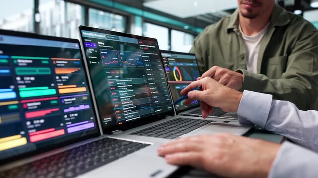 Cybersecurity Analysts Reviewing Risk Findings On Laptop