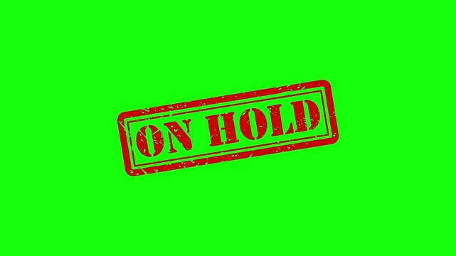 On hold red rubber stamp animation on green screen, business status concept red stamp