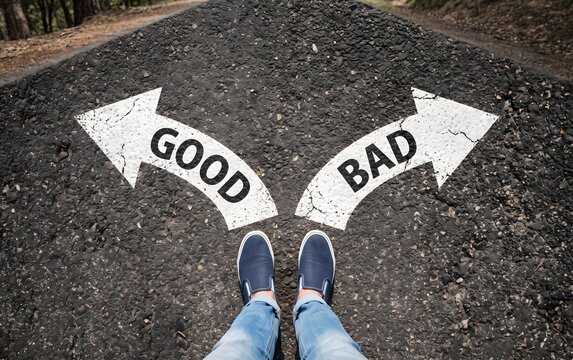 Person standing at a crossroads choosing between good and bad