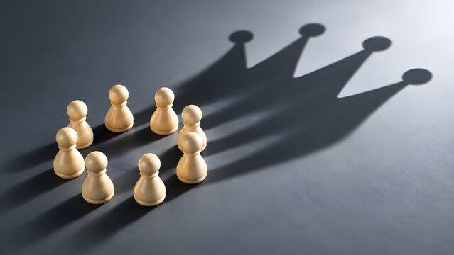 Leadership and potential concept featuring wooden pawn circle casting king crown shadow on dark surface