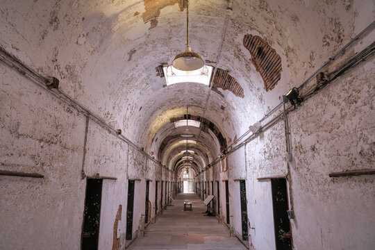 Hanging lamp under the vaulted ceiling of a cellblock at a historic penitentiary in Philadelphia, Pennsylvania, United States