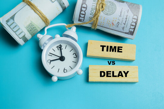 Concept of time vs delay text on wooden blocks.