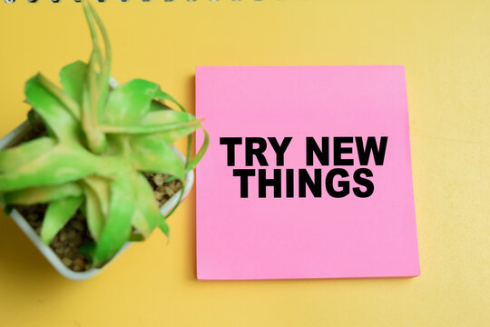 Concept of try new things write on sticky notes isolated on table.