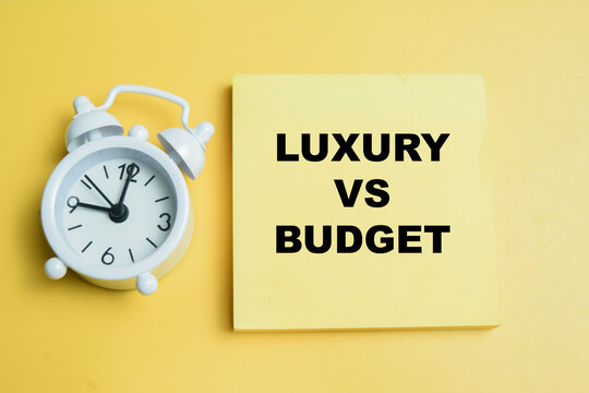Concept of luxury vs budget write on sticky notes isolated on table.