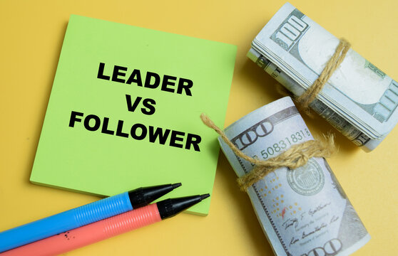 Concept of leader vs follower write on sticky notes isolated on table.
