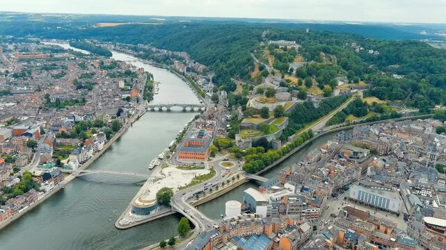 Namur, Belgium. Citadelle de Namur, vast stone fortress crowning a forested hill above the Meuse and Sambre rivers, aerial panoramic view on a summer day. Drone footage, Point of interest