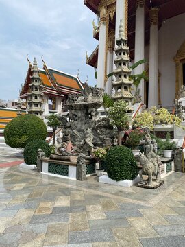 Chinese stone statues in a traditional garden at Wat Suthat, Bangkok, Thailand