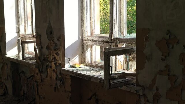 Abandoned building with worn-out exterior, peeling paint and a worn-out window