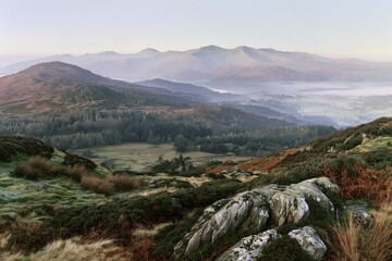 Fototapeta premium Misty Mountain Landscape with Forest and Rocky Foreground