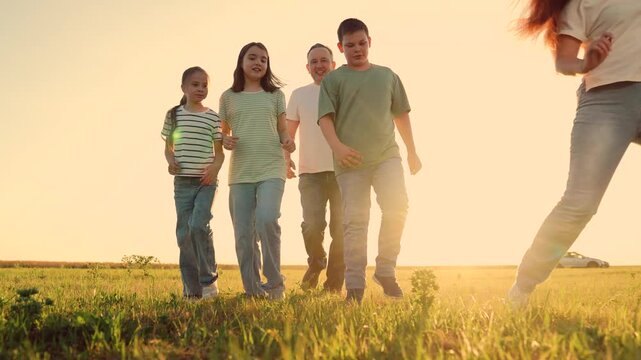 Parents run with child kid playing football green lawn, children kicking ball, mother father girl boy happy family sunset, weekend family fun, trust, unity, outdoor recreation image: family soccer